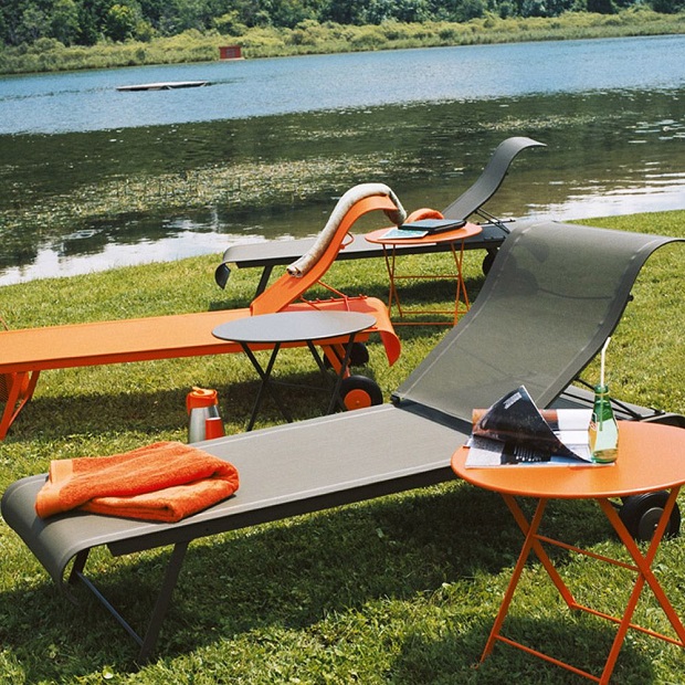Fermob Dune sunloungers next to a lake