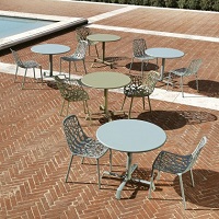 Forest dining chairs and tables by Fast on a patio