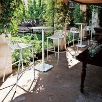Forest high stools and high tables by Fast in a garden setting