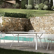 Radice quadra table by Fast next to a swimming pool