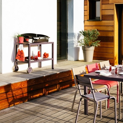 The Quiberon side table with a barbecue in a decked garden patio